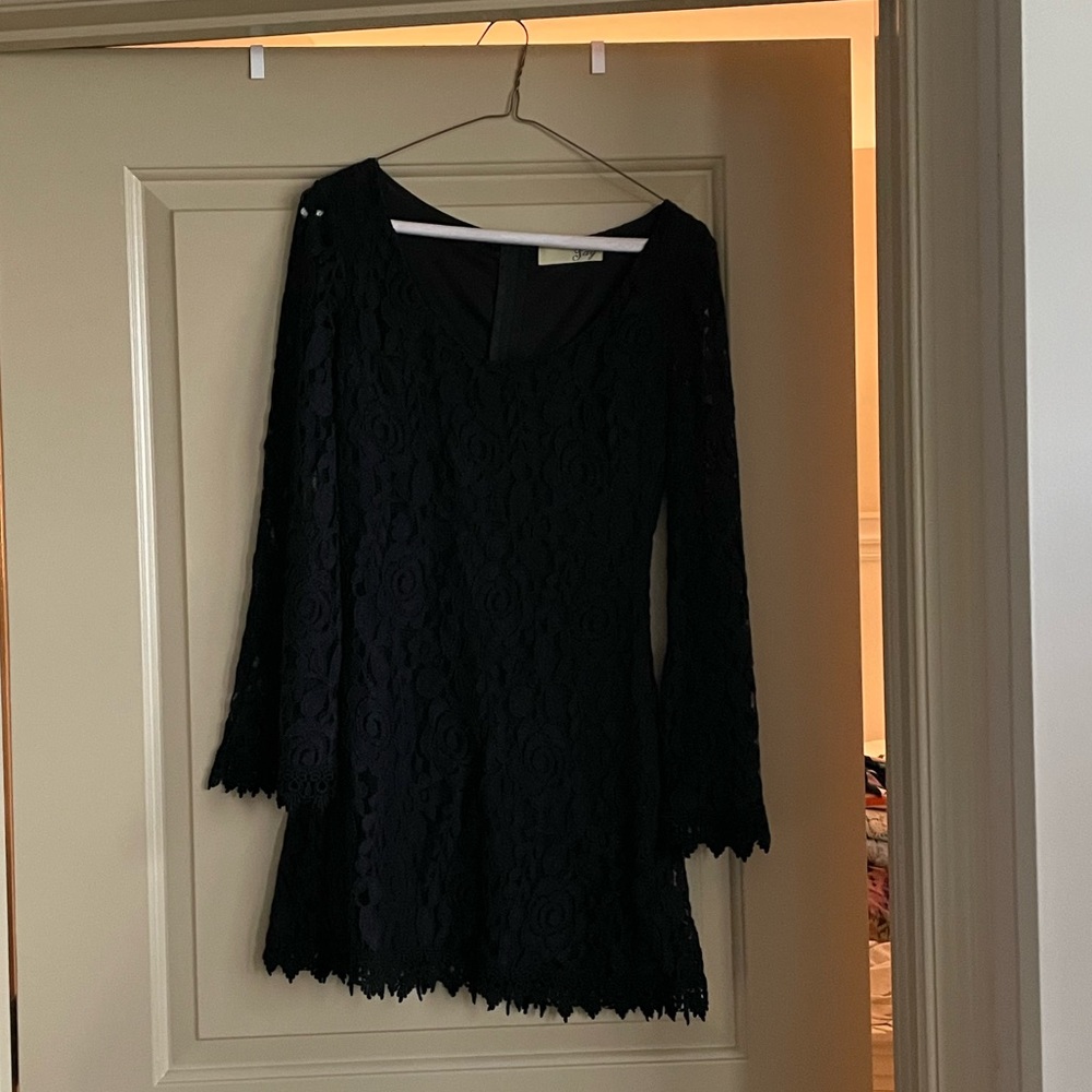 Short fitted black long-sleeve mini dress with lovely lace detailing